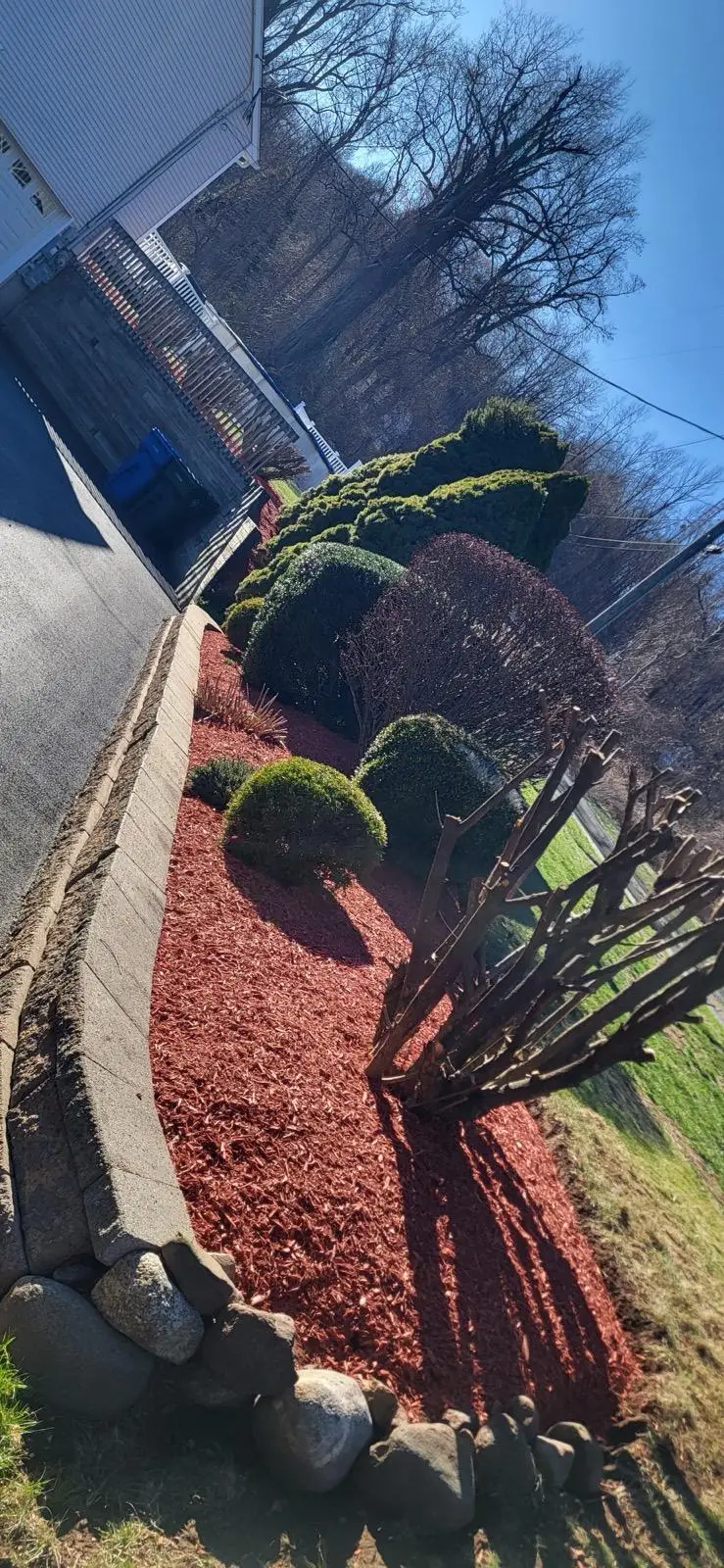 Landscaping crew mowing and edging a lawn in Connecticut